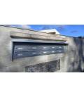 Agrupación de 10 buzones Milenio, color Plata anodizado. Colgados en la pared y tejado.