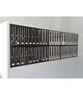 Instalación de SoloBuzones, Agrupación de 50 buzones Cosmos Front-71180-Inox Brillo, empotrados por la pared.
